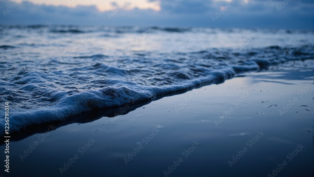 Tranquil waves reflecting twilight sky on black shore Tranquil waves reflecting twilight sky on black shore