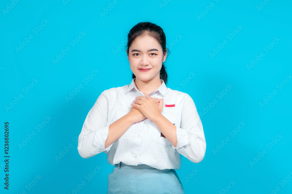 Portrait female student showing Gratitude With Hands on Chest in Bright Setting Portrait female student showing Gratitude With Hands on Chest in Bright Setting
