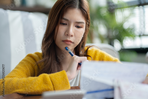 stressed woman trying money to pay credit card debt and worry by calculate expense from invoice or electricity bill,water bill not able money to pay mortgage.debt,loan,bankruptcy,Bad financial concept photo