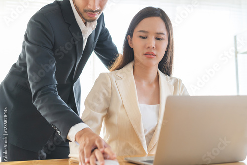 Disgusted asian young employee, pressure business woman uncomfortable, looking hand of boss or colleague  male when touching her hand while working. Sexual harassment inappropriate at office work.