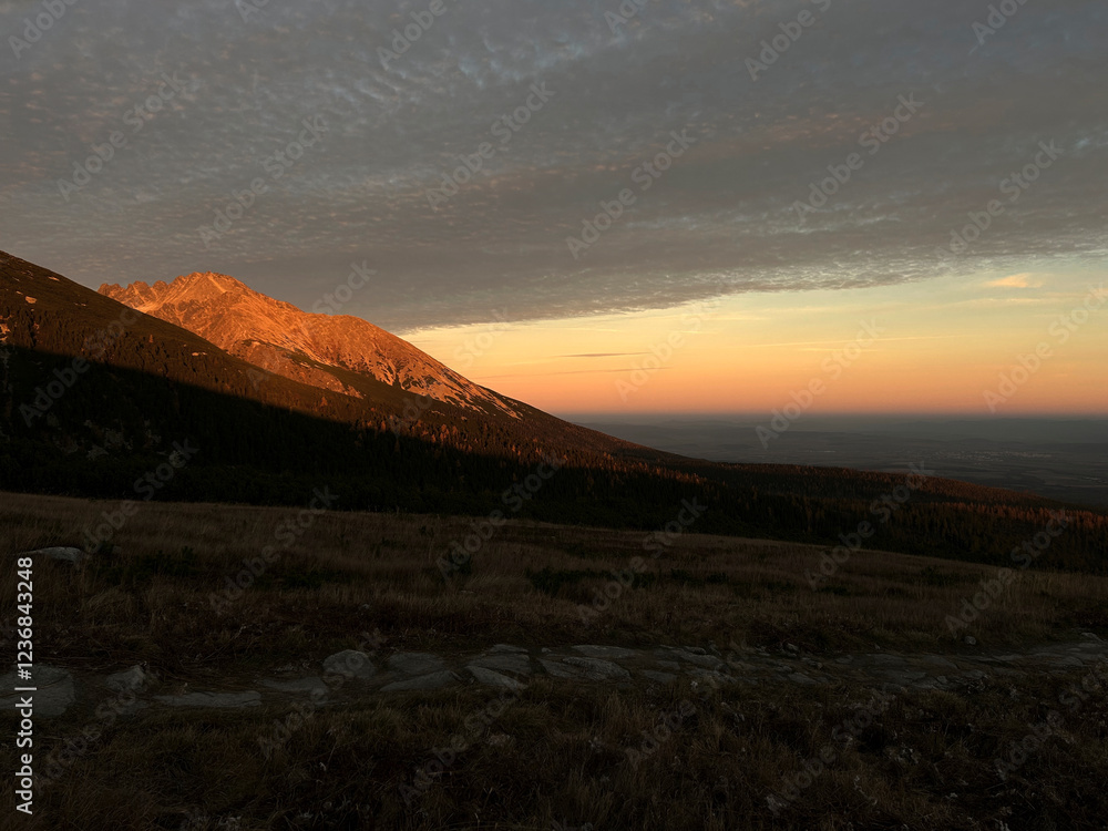 Orange peaks of mountains watching sunset from a bird's eye view Orange peaks of mountains watching sunset from a bird's eye view