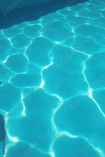 Ripples disturb the otherwise calm pool surface, clear water, sunlight photo