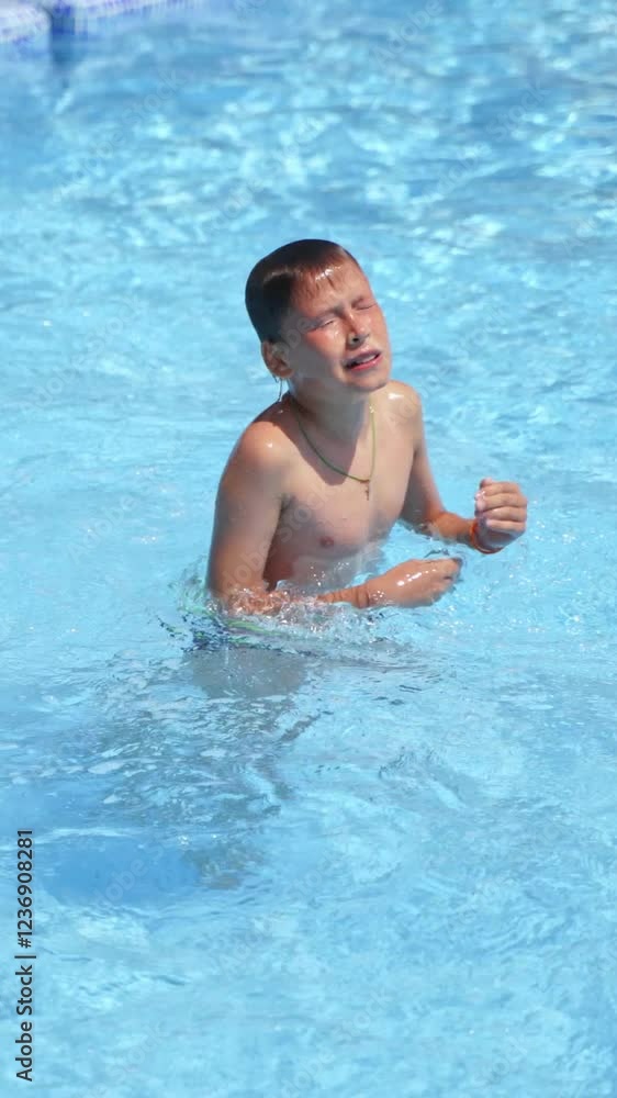 Boy in the swimming pool. Teenage boy jumping underwater outdoors. Happy childhood. Summer vacation near the pool. Vertical video Boy in the swimming pool. Teenage boy jumping underwater outdoors. Happy childhood. Summer vacation near the pool. Vertical video