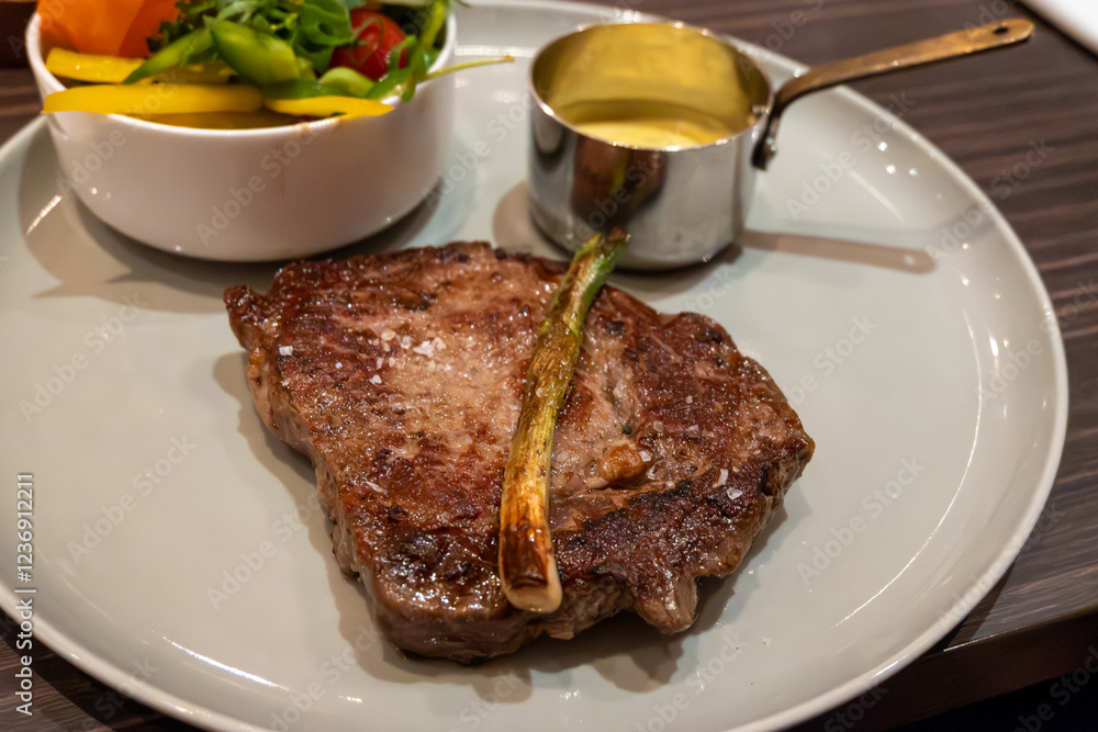 Large beef rib eye steak grilled on gas stove in German restaurant Large beef rib eye steak grilled on gas stove in German restaurant