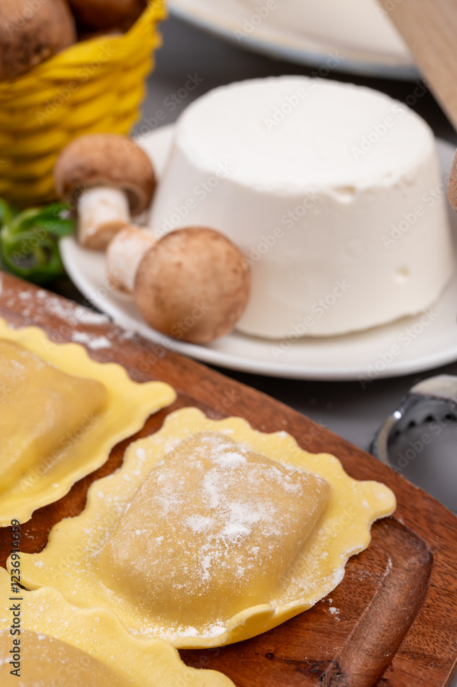 Italian food, fresh home made stuffed pasta ravioli dumplings with ricotta soft cheese and champignons porcini mushrooms, Parma, Emilia Romagna, Italy Italian food, fresh home made stuffed pasta ravioli dumplings with ricotta soft cheese and champignons porcini mushrooms, Parma, Emilia Romagna, Italy