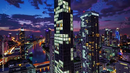 Wallpaper Mural A breathtaking 4K ultra-HD aerial stock video capturing the vibrant Bangkok city skyline at dusk, as the city lights begin to glow against the deep blue and purple hues of the evening sky.  Torontodigital.ca
