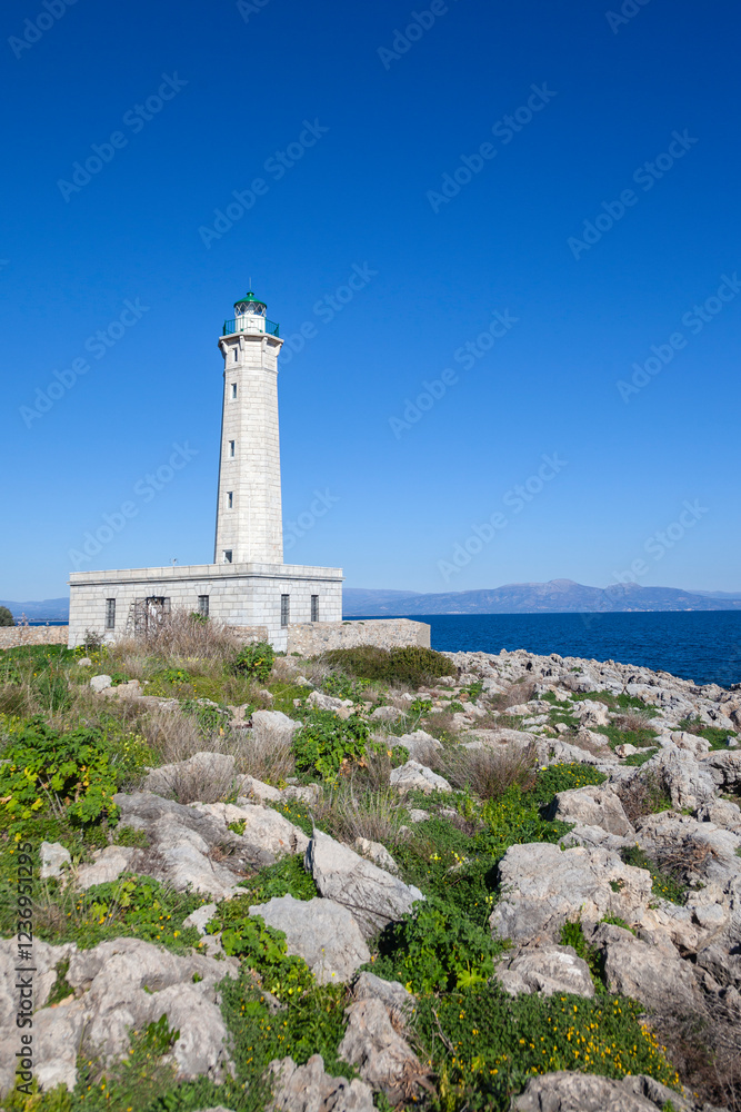 The historic lighthouse of Kranae, Gytheio, in Laconia, Greece. A stunning maritime landmark on the rocky coastline with panoramic sea and sky views.