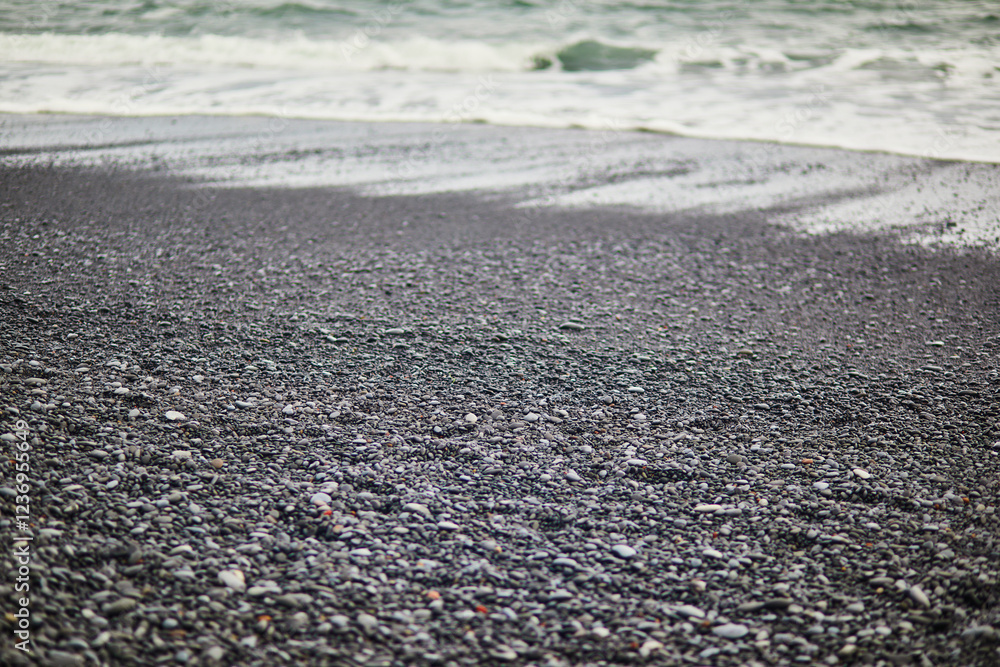 Closeup of black sand at Reynisfjara black sand beach near Vik in Southern Iceland. Closeup of black sand at Reynisfjara black sand beach near Vik in Southern Iceland.