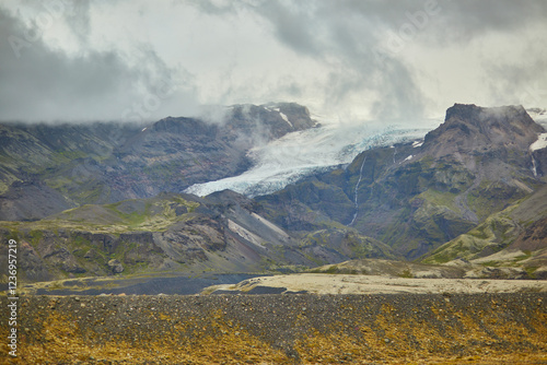 Scenic view of black volcanic mountains and Vatnajokull (Vatna glacier) in Iceland. photo