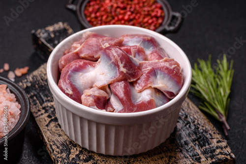 Raw chicken or turkey gizzards with salt, spices and herbs photo