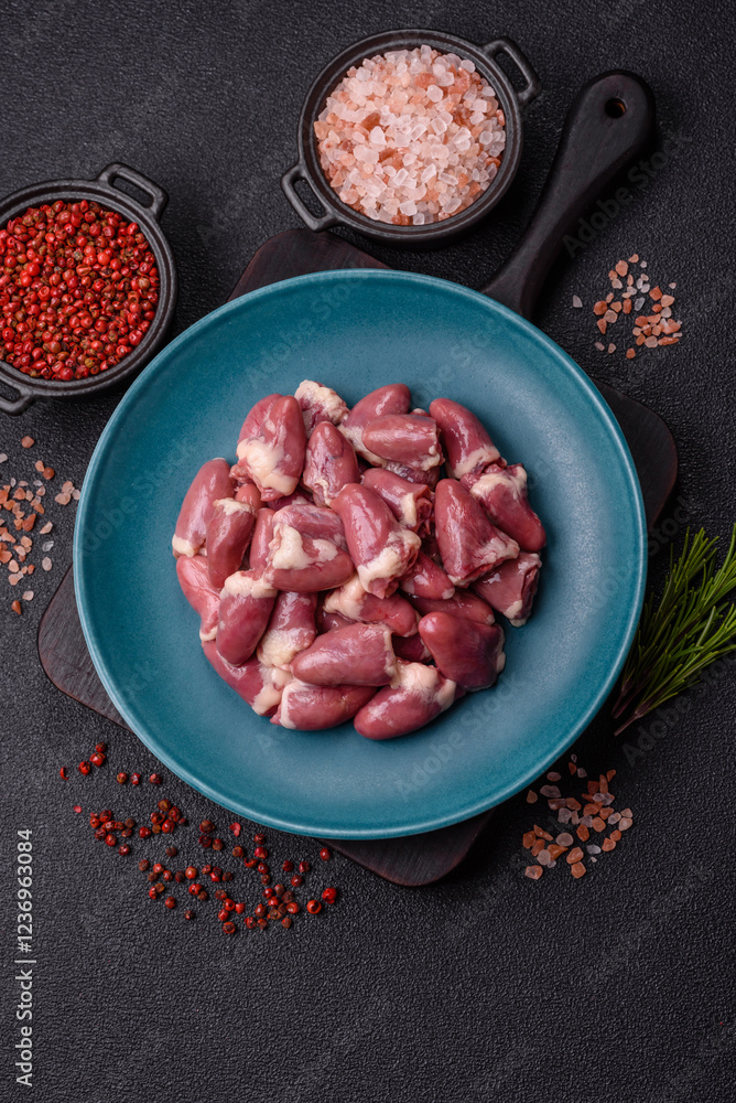Raw chicken hearts with salt, spices and herbs Raw chicken hearts with salt, spices and herbs