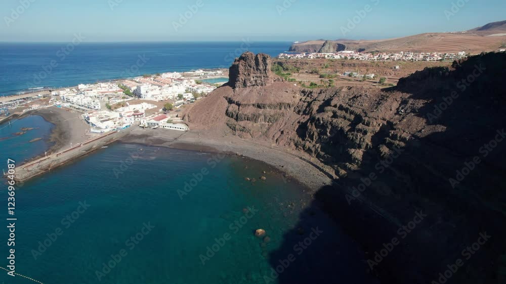 Aerial view over Puerto de Las Nieves and the beach in Agaete on a sunny day, Gran Canaria island. Spain. Aerial view over Puerto de Las Nieves and the beach in Agaete on a sunny day, Gran Canaria island. Spain.