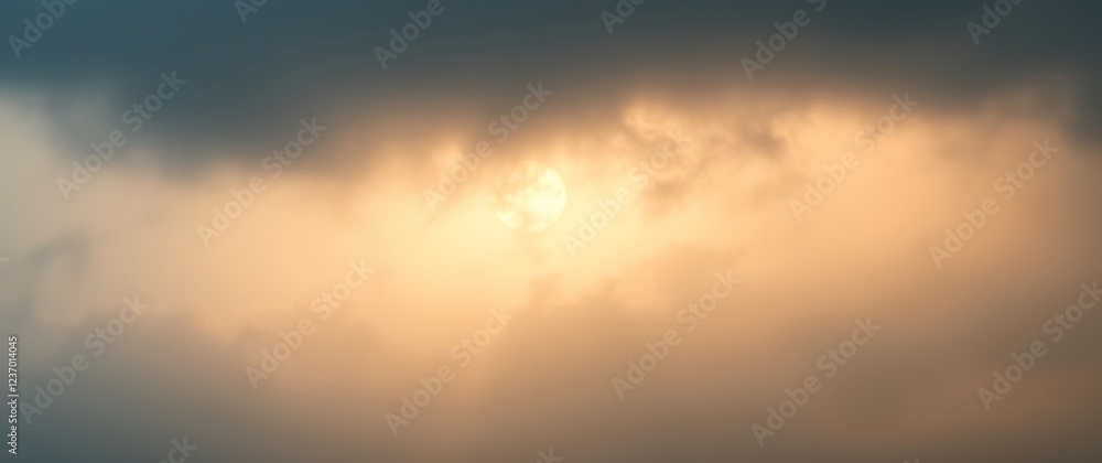 Fototapeta premium Light breaking through clouds at dusk over a calm horizon