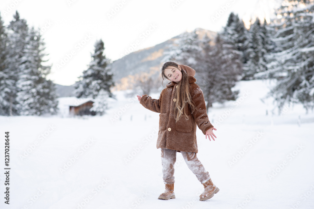 Obraz premium Cute little girl in winter walks in winter snow-covered forest. Winter Activities, Pastime, Walk