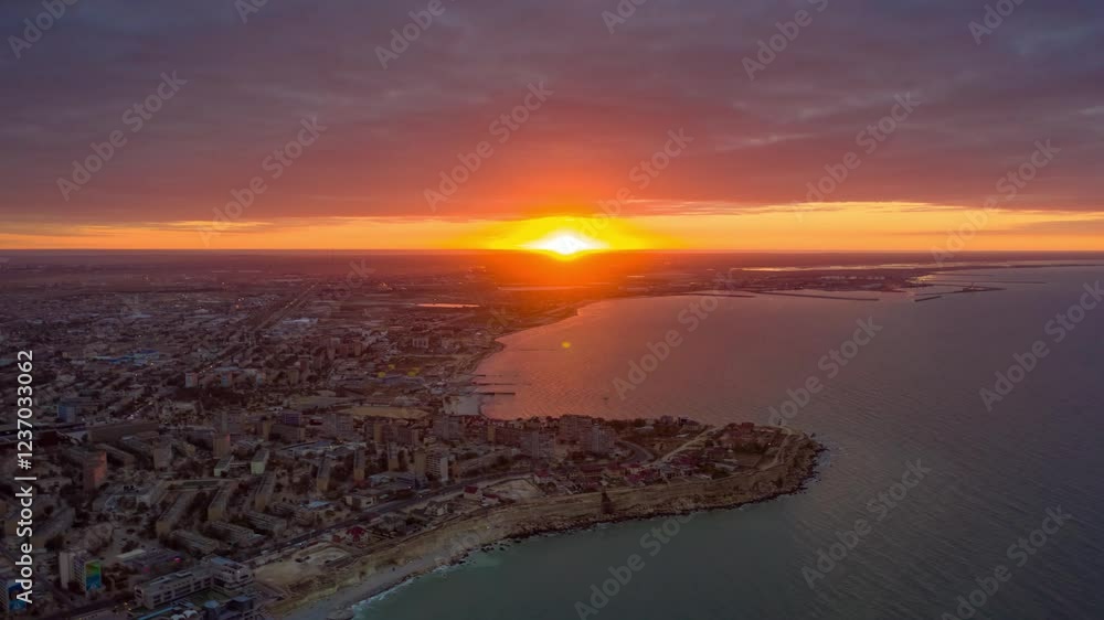 AKTAU, KAZAKHSTAN - FEBRUARY 1, 2025: Stunning sunrise over the Caspian Sea illuminating the coastal city and its modern skyline AKTAU, KAZAKHSTAN - FEBRUARY 1, 2025: Stunning sunrise over the Caspian Sea illuminating the coastal city and its modern skyline