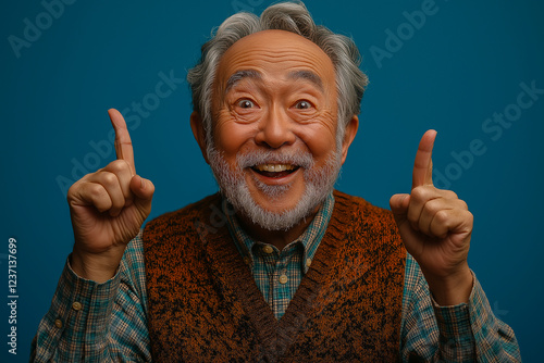 Portrait of an elderly Asian man on a blue background.