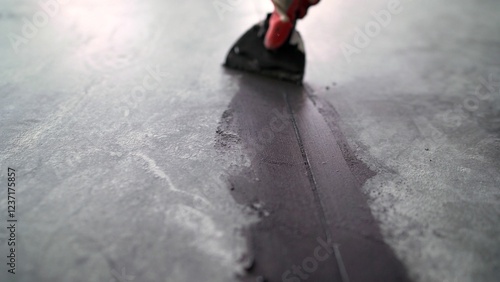Cuadro en lienzo Construction professional carefully spreading dark sealant along concrete expans