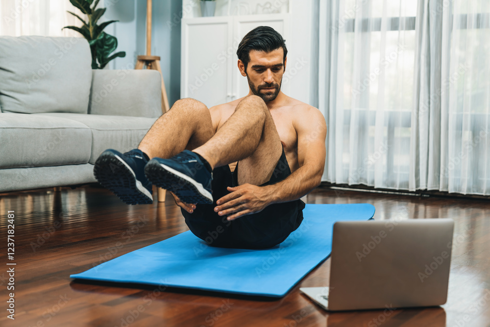 Obraz premium Athletic and sporty man doing crunch on fitness mat while follow online home workout exercise instruction for fit physique and healthy sport lifestyle at home. Online gaiety home exercise video.