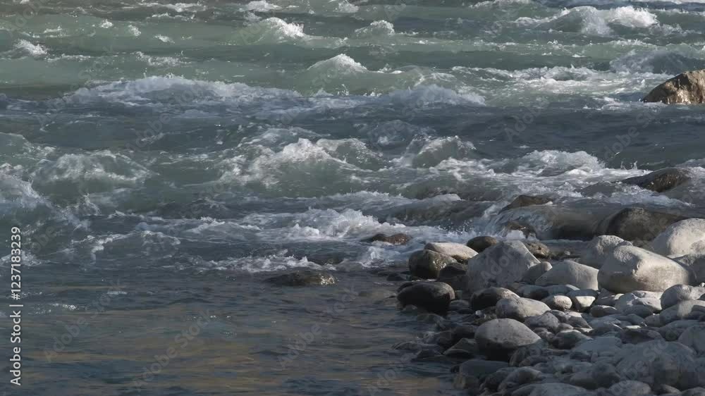 Seething water quickly flows over the stones. Mountain river in autumn, slow motion Seething water quickly flows over the stones. Mountain river in autumn, slow motion