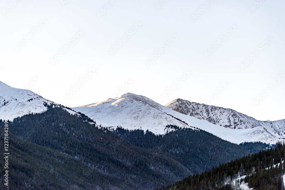Obraz premium Frisco, Colorado Western Slope snowcapped rocky mountains of Gore Range in winter weather sunrise with spruce pine forest pattern