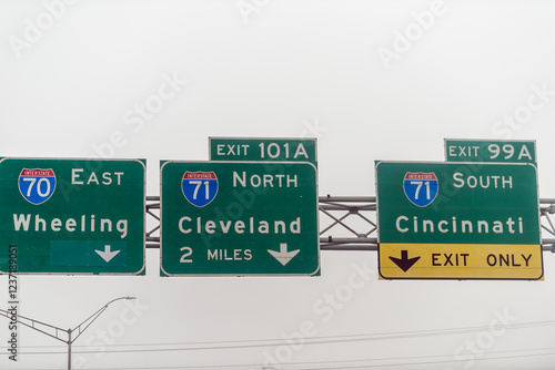 Columbus, Ohio highway 70 road in midwest city with fog mist cloudy day, exit signs for Wheeling Cleveland and Cincinnati