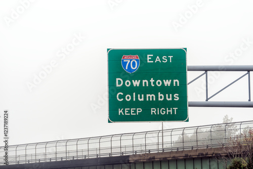 Columbus, Ohio interstate highway 70 road with fog mist and sign for downtown right exit