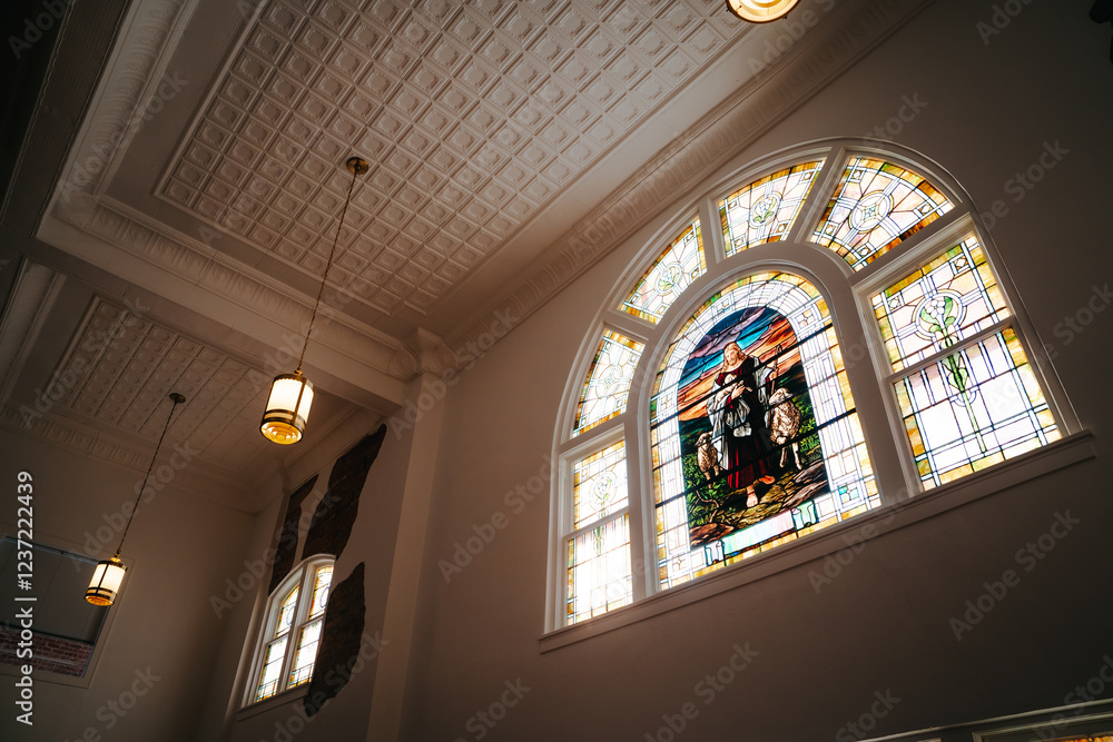 Obraz premium Stained glass of Jesus holding lambs, presbyterian