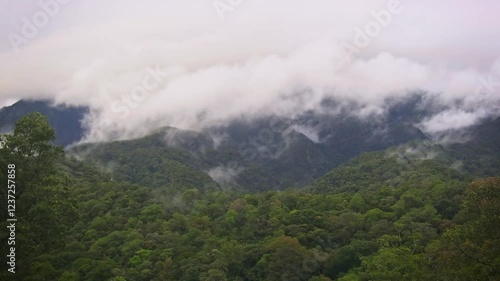 Mount Kinabalu Gayo Ngaran or Nulu Nabalu or Gunung Kinabalu is the highest mountain in Borneo and Malaysia, protected Kinabalu Park, World Heritage Site. Landscape mountain view with moving clouds. photo