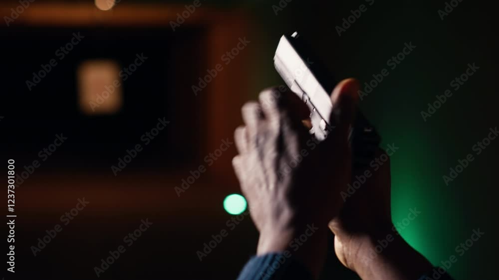 Man reloading handgun in indoor shooting range, following safety ...