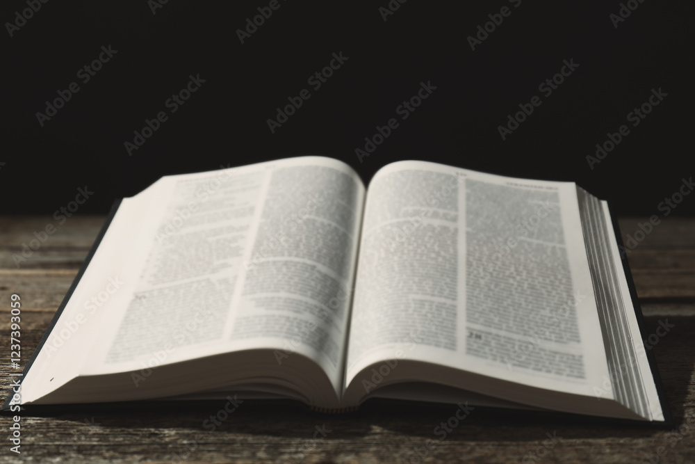Open Holy Bible in English language on wooden table Open Holy Bible in English language on wooden table