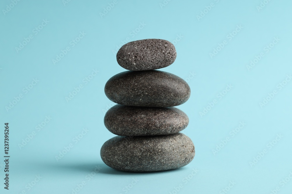 Stack of rocks on light blue background. Harmony and life balance Stack of rocks on light blue background. Harmony and life balance
