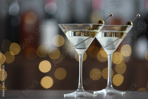 Wallpaper Mural Martini cocktail with olives in glasses on wooden table against blurred background, closeup. Bokeh effect Torontodigital.ca