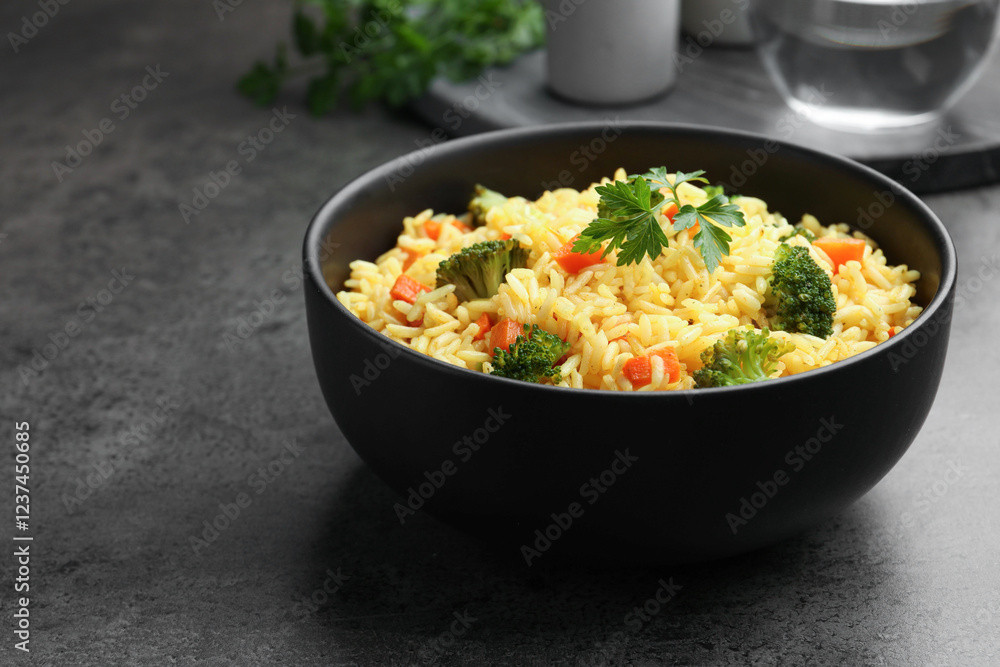Tasty rice with vegetables on grey table, closeup. Space for text Tasty rice with vegetables on grey table, closeup. Space for text