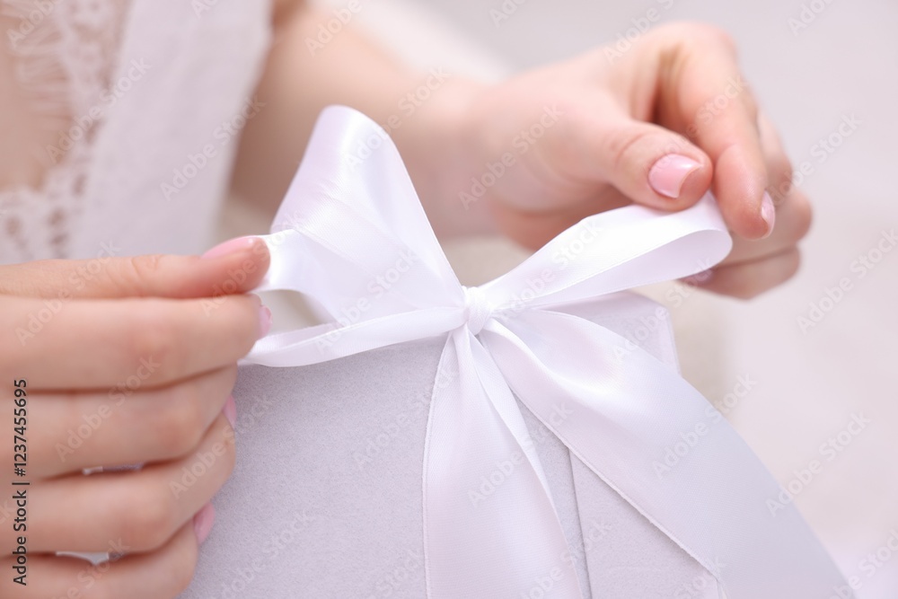 Bride opening beautiful wedding gift indoors, closeup Bride opening beautiful wedding gift indoors, closeup