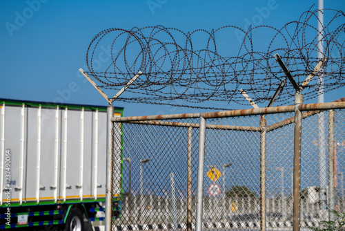 Sharp barbed wire border fence blocking access. Surveillance, conflict, and restricted freedoms, reflecting geopolitical divisions and the impact of immigration policies on displaced people. photo