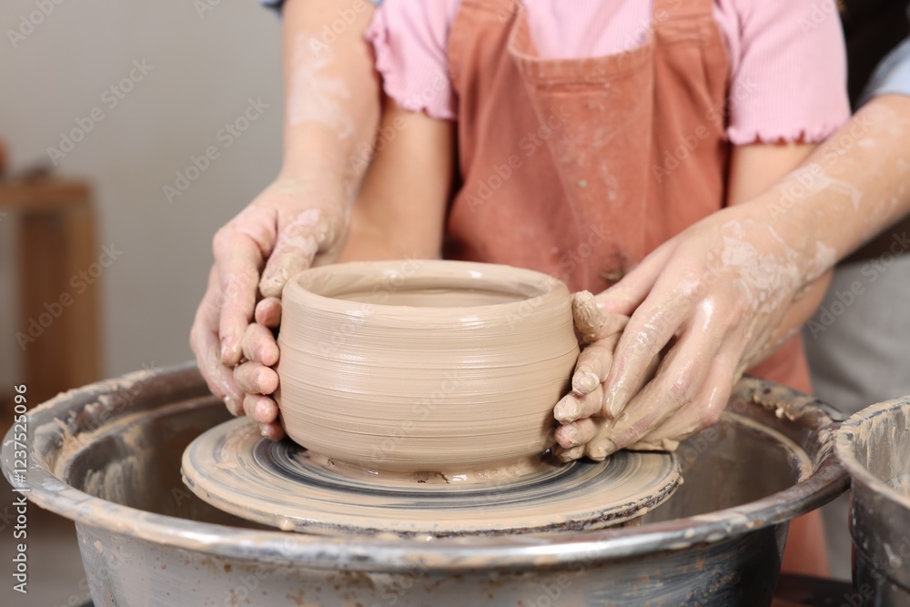 Hobby and craft. Daughter with her mother making pottery indoors, closeup Hobby and craft. Daughter with her mother making pottery indoors, closeup