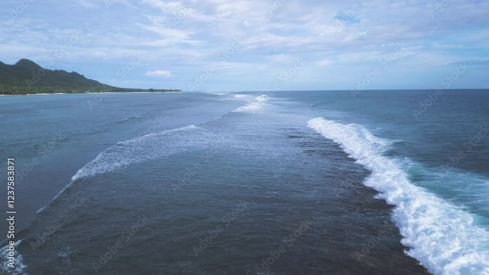 Towering waves crash and roll whitewash over fringing reef of Rarotonga Cook Islands Towering waves crash and roll whitewash over fringing reef of Rarotonga Cook Islands