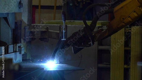 
Robotic mechanism performing precise welding tasks in an industrial factory setting, showcasing automation in manufacturing.