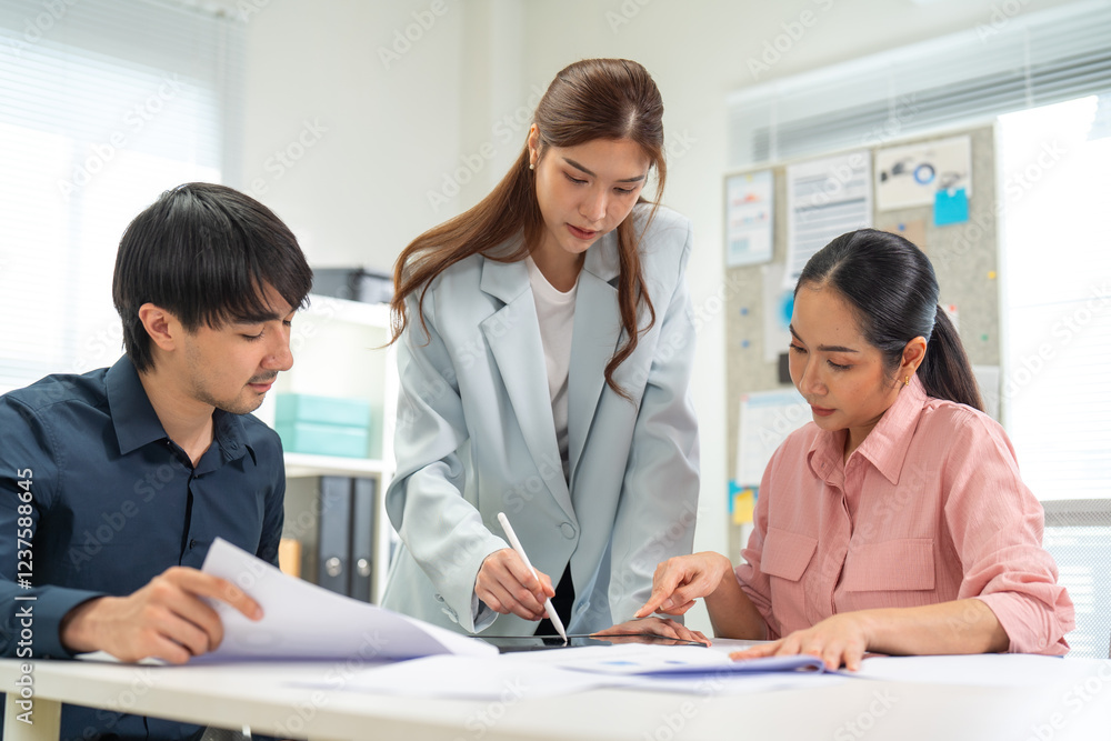 Three professionals collaborate on a project, discussing documents and strategies in a modern office setting, showcasing teamwork and focus. Three professionals collaborate on a project, discussing documents and strategies in a modern office setting, showcasing teamwork and focus.