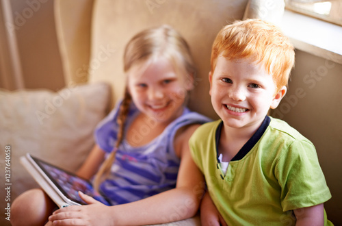 Tablet, portrait and children on sofa in home playing educational online game for learning together. Happy, siblings and kids on digital technology watching movie on streaming app in living room.