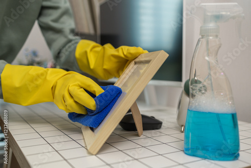 Wallpaper Mural the wife is cleaning her husband home office, cleanup the room, wearing rubber glove to protect her hands, the housekeeper is cleaning the house, tidy up Torontodigital.ca