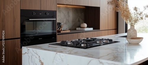 Modern kitchen interior featuring marble countertop and sleek appliances in b...