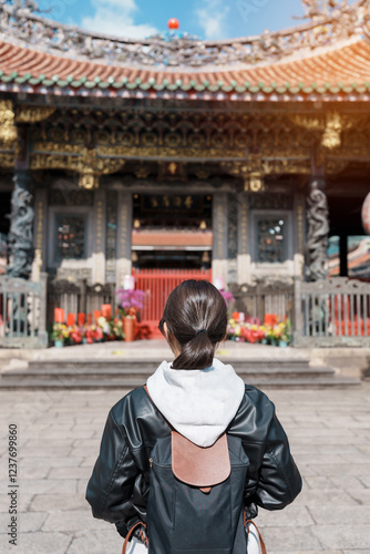 woman traveler visiting in Taiwan, female Tourist sightseeing at Longshan Temple, Chinese folk religious temple in Wanhua District, Taipei City. landmark and popular. Travel and Vacation concept photo