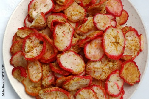 Close up of spicy seblak crackers on white isolated plate