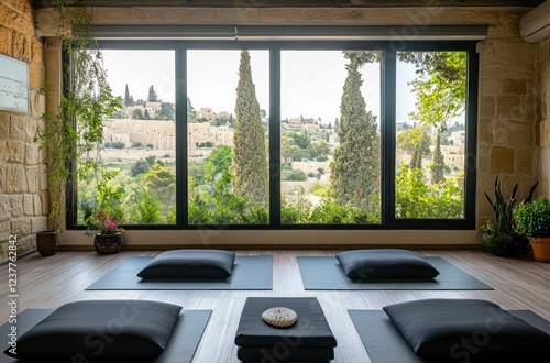 The yoga studio is located on the upper floor of an old house, with large windows overlooking ancient Jerusalem and green hills outside.  photo