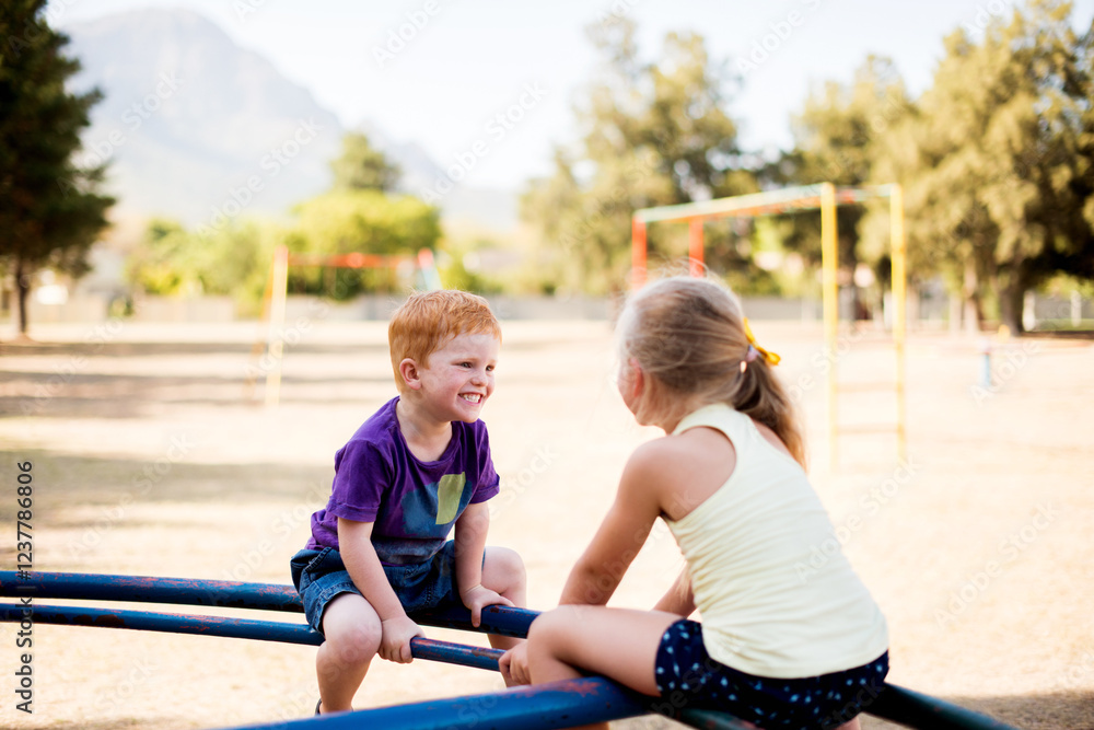 Fototapeta premium Smile, children and play on merry go round at park for summer fun, obstacle course and bonding together. Kids, ride and playground equipment with fine motor skills, active entertainment and childhood
