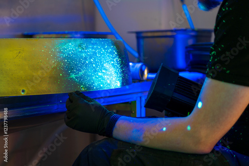 Industrial FPI testing showing fluorescent indications under blacklight examination. Non-destructive testing method revealing surface discontinuities with penetrant inspection