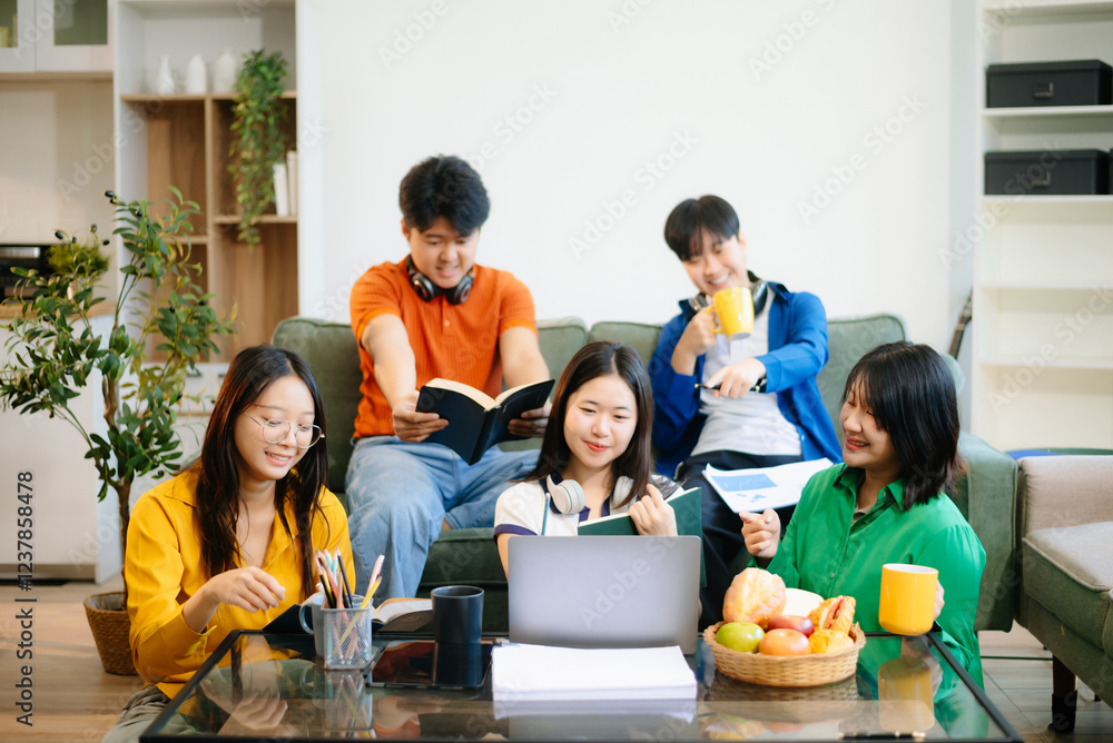 Group of young Asian students working on a project with laptops and tablets. Cozy indoor setting, teamwork, Group of young Asian students working on a project with laptops and tablets. Cozy indoor setting, teamwork,