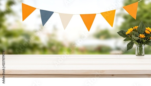 Colorful bunting decorates a bright outdoor setting with a flower vase on a wooden table