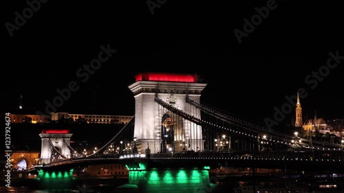 Chain Bridge in Budapest illuminated in Hungarian flag color, highlighting the vibrant nightlife and iconic architecture of the city. Travel to Budapest, Hungary. 4k video